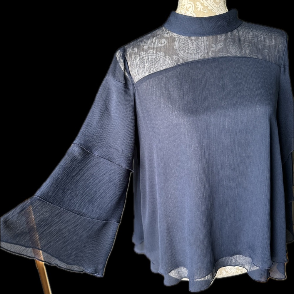 Beautiful light fabric top. Blouse with flair. Runs 1 to 2 sizes big.